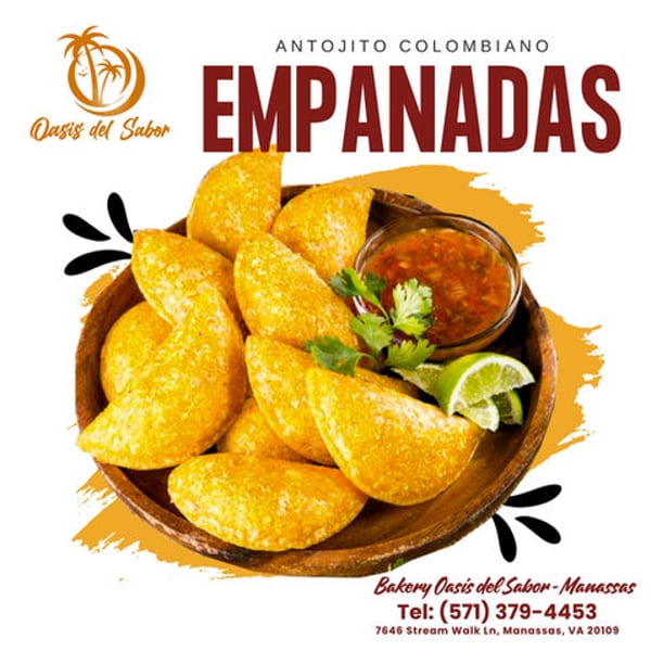 Golden Colombian empanadas with salsa, cilantro, and lime wedges in a wooden bowl.